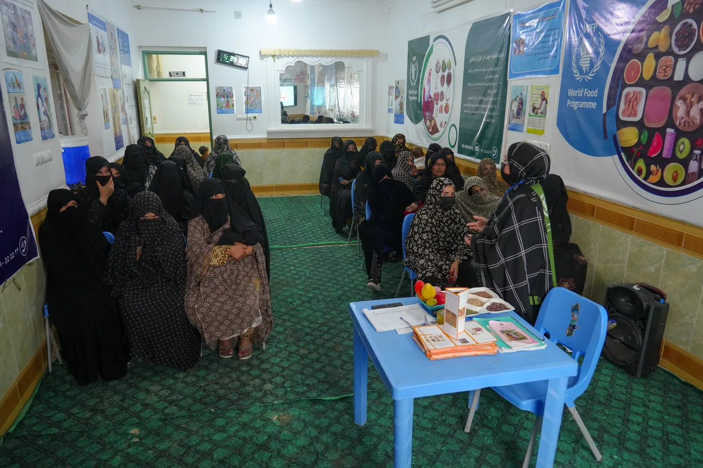Women attend a maternal and child health session at an FSCWEO center