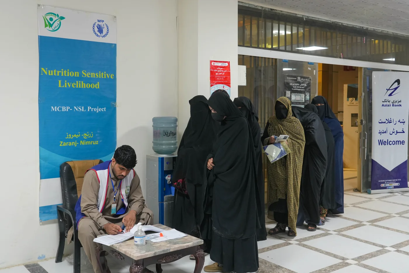Women wait at a maternal and child benefit program service point in Nimruz