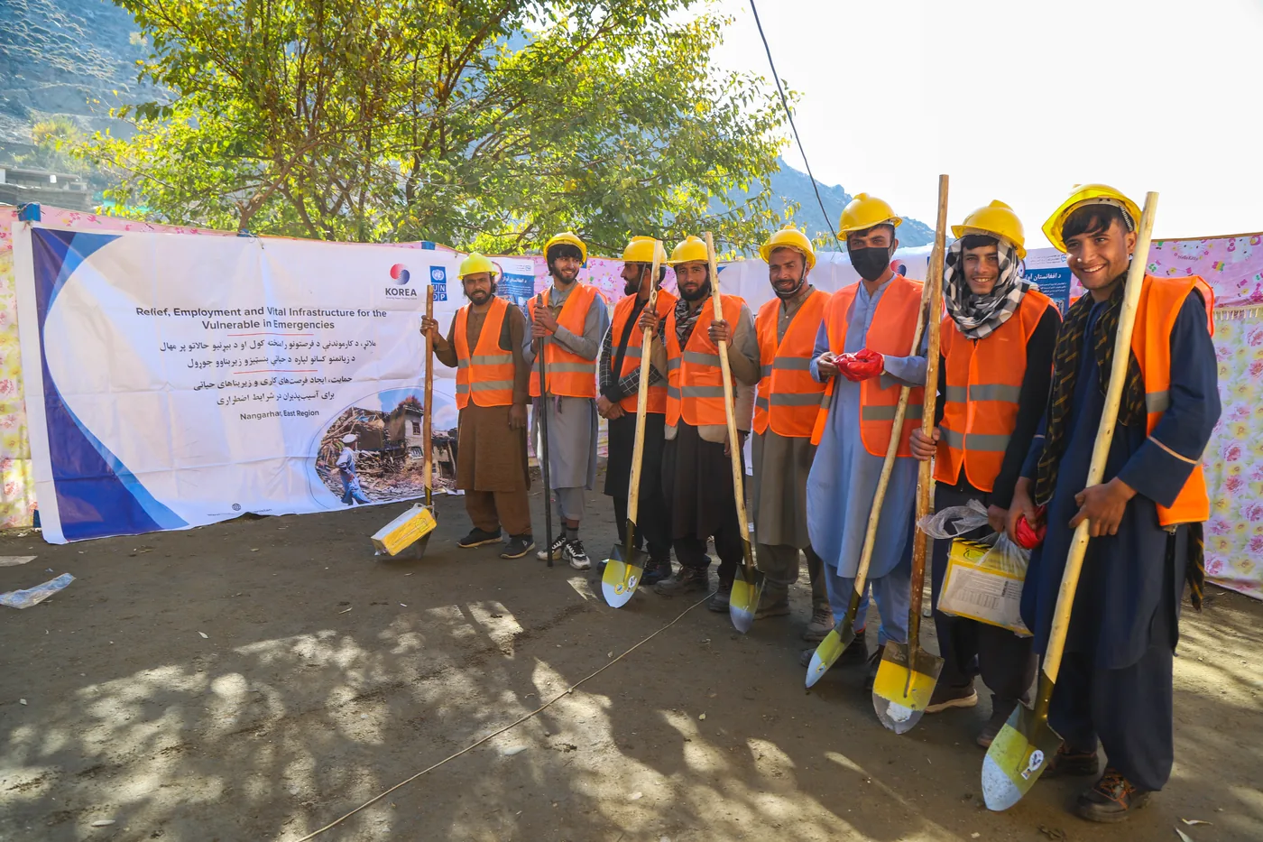 FSCWEO field workers stand with tools and protective equipment
